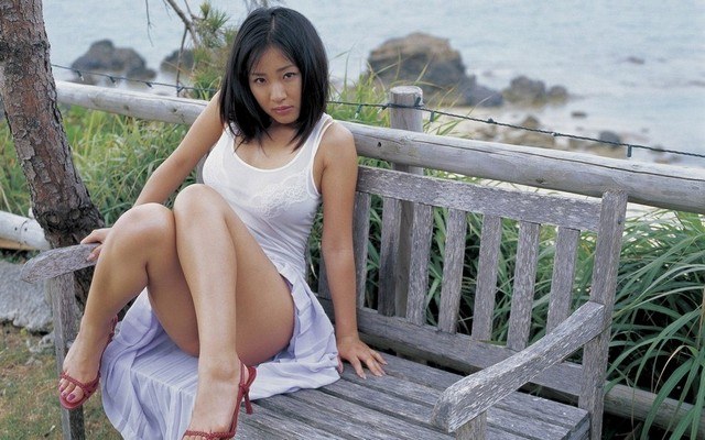 Cute Asian Model Sitting On Bench